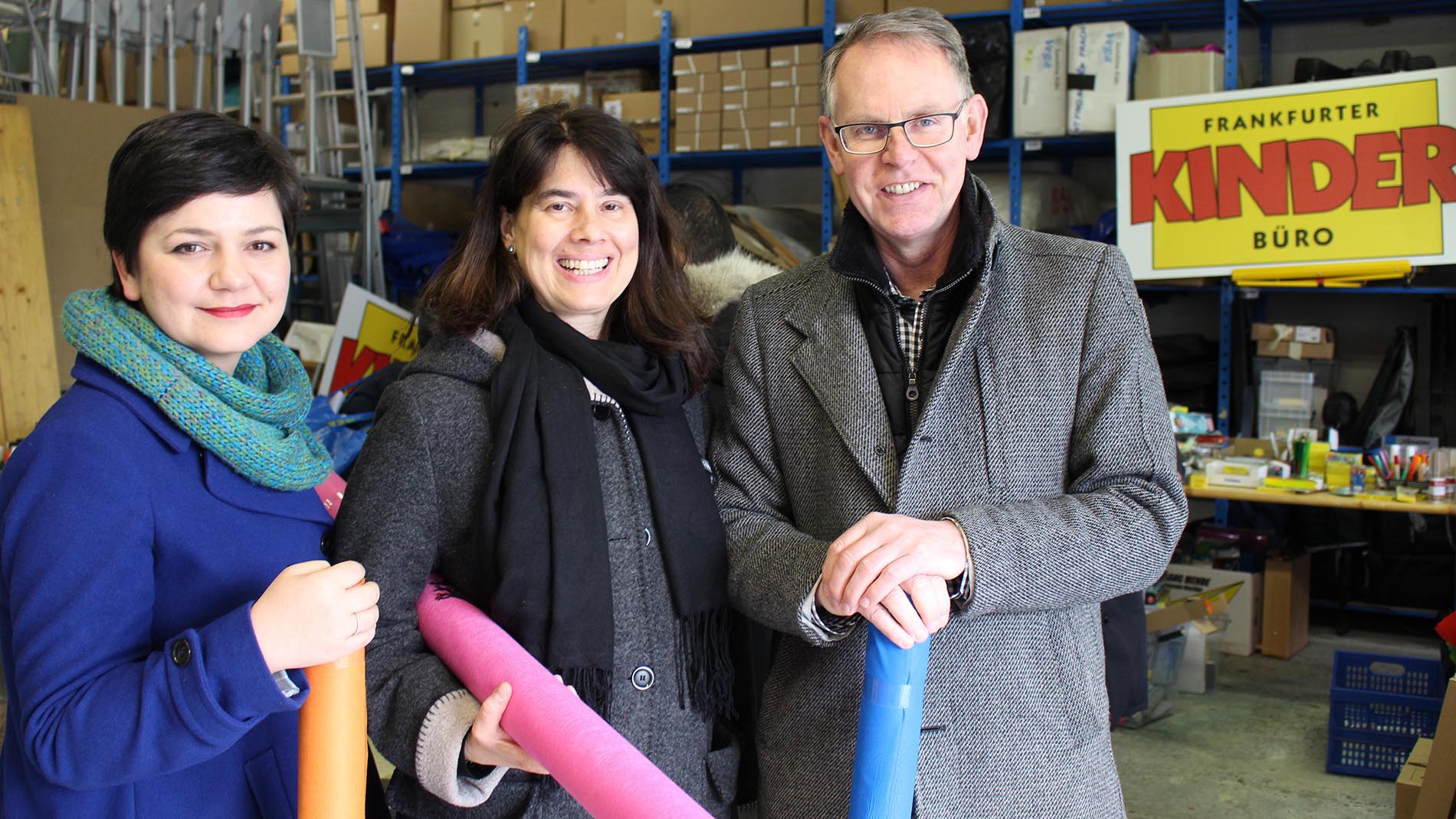 Margit Herberth, Director of Consumer Marketing and Communication, Messe Frankfurt, Madeleine Michaelis, Project Leader, Frankfurter Kinderbüro, and Michael Reichhold, Creativeworld Director, Messe Frankfurt, at the distribution of donations in the Frankfurter Kinderbüro storeroom.