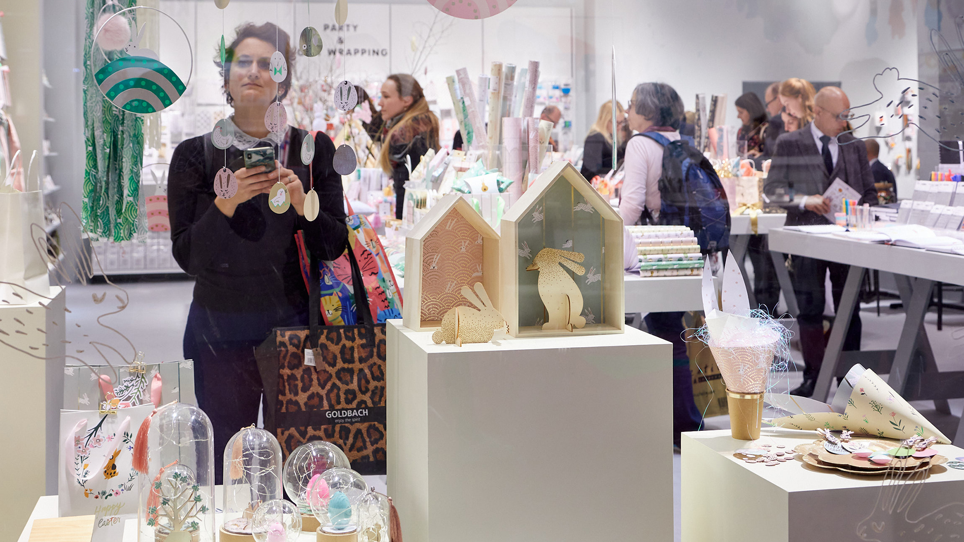 A woman at a booth at Creativeworld