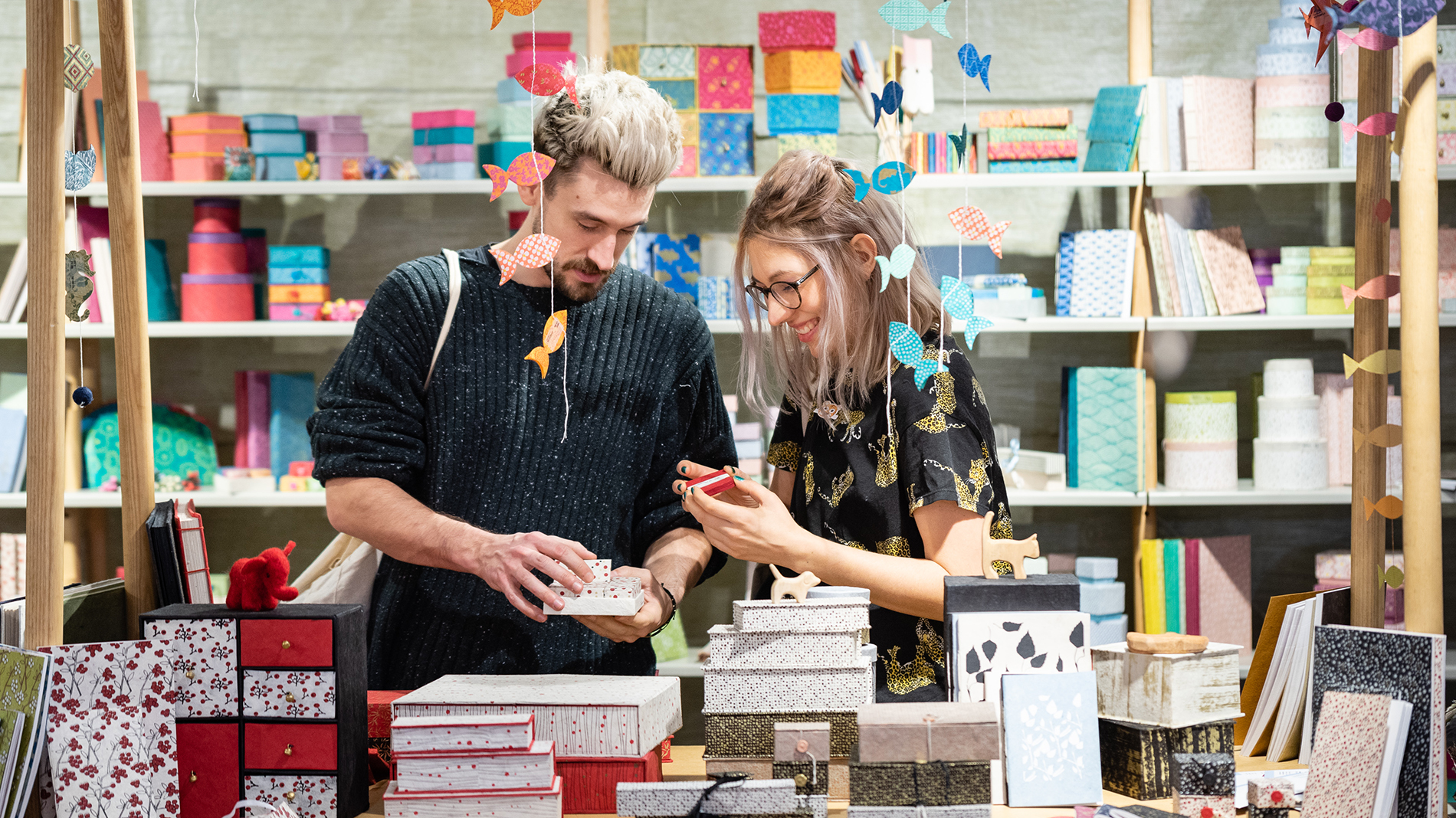 Man and woman at a stand with gift boxes at Creativeworld
